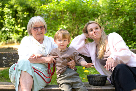 Three Generations Relaxing Park Together