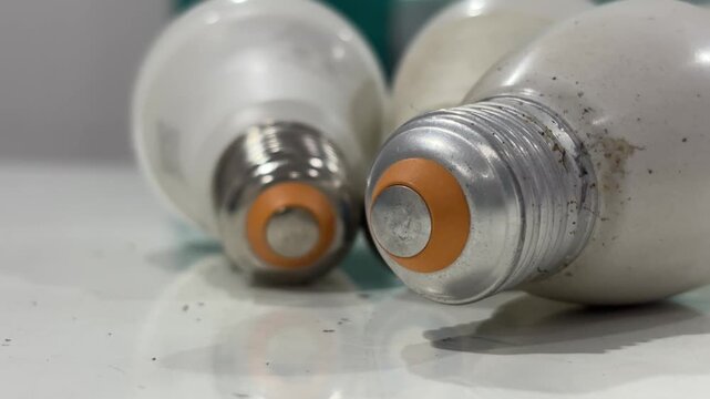 Close-up view of a few old Edison screw light bulb lying on a tabletop. Electricity concept.