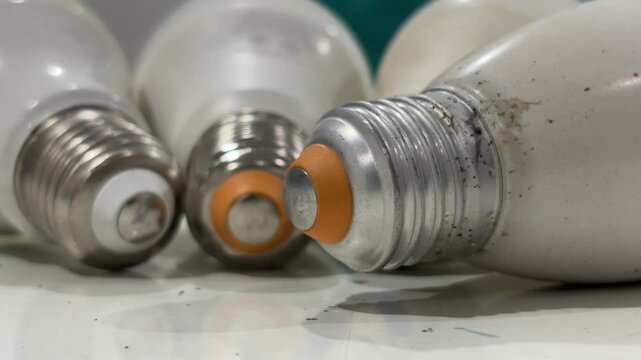 Close-up view of a few old Edison screw light bulb lying on a tabletop. Electricity concept.