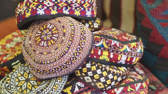 Colorful hats and cushions displayed at a market