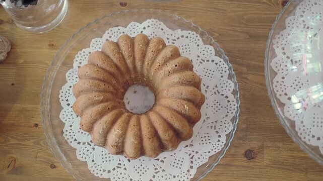 Bundt cake on a table with lace doily