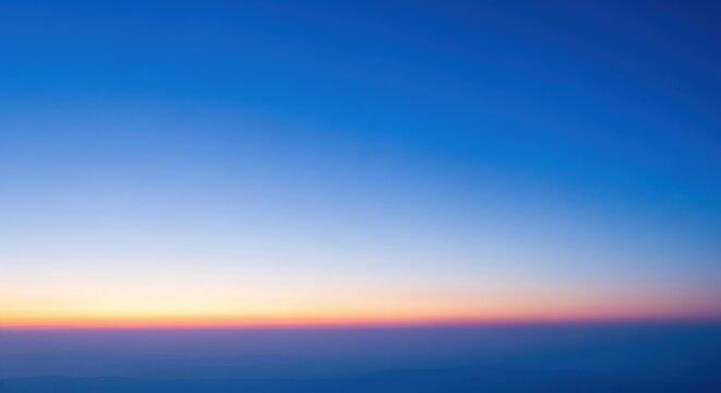 Vast blue sky gradient with subtle sunset colors at the horizon
