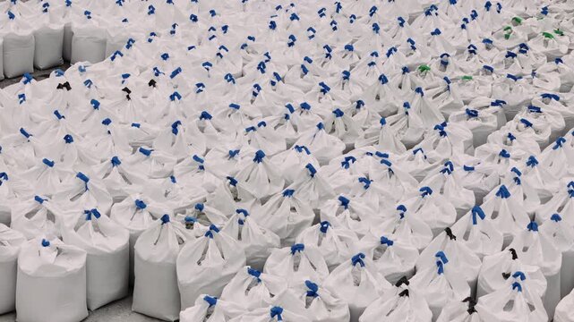 Bags filled with gravel and aggregate at a marble quarry storage area