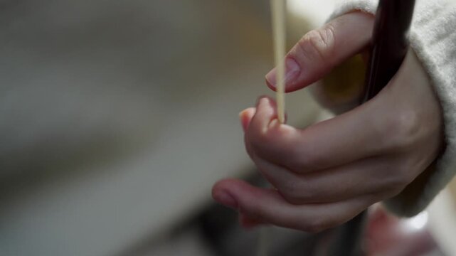 Detailed close-up of a musician's hand pressing strings on a traditional instrument 해금 현을 섬세하게 짚고 누르는 연주자의 손가락 클로즈업
