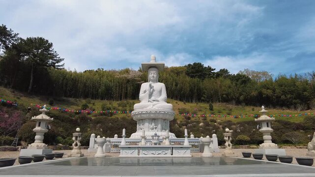 Majestic stone Buddha statue in a traditional Buddhist temple courtyard in South Korea