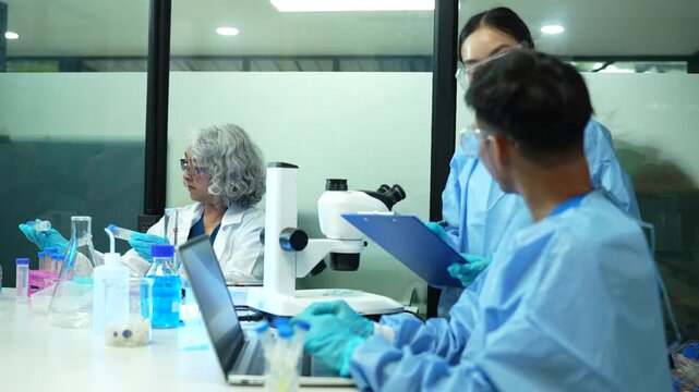  environmental scientists analyzing water quality samples with centrifuge and petri dish in laboratory.