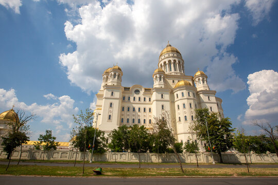 The majestic Romanian Peoples Salvation Cathedral with golden domes under a cloudy sky in Bucharest Romania