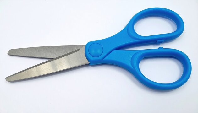 Blue plastic childrens scissors on white background
