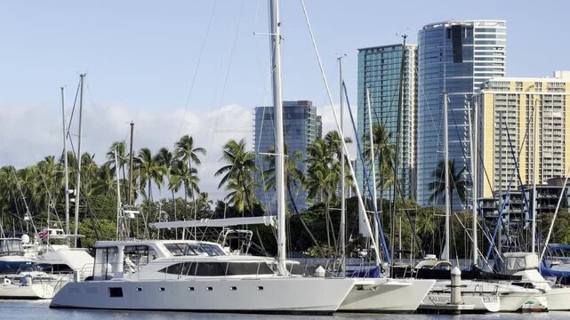 The Hawaii Yacht Club, located at the mouth of the Ala Wai Canal.  Ala Wai Boat Harbor, City of Honolulu, Oahu, Hawaii. The high-rise buildings are apartments and hotels.