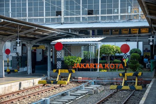 Jakarta, Indonesia - July 02, 2026: Jakarta Kota Station with its orange station sign, buffer stops, dead-end tracks, and historic station facade.