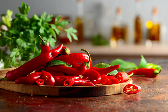Heap of red hot chili peppers on a kitchen table.