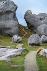 A gravel walking path winds gently through towering limestone boulders at Castle Hill (Kura Tawhiti) in the Canterbury high country, South Island, New Zealand. © ting_149