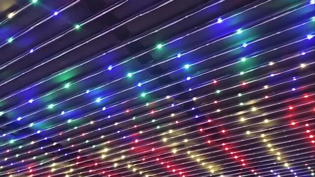 Colorful RGB LED strip lights mounted on metal frame background for party, event, or stage decoration.