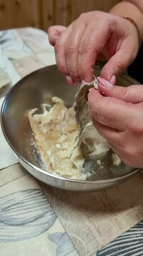 Woman's hands preparing salted cod fish for cooking