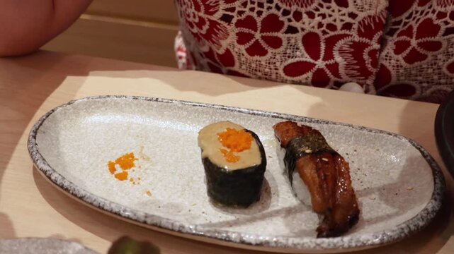 Delicious Japanese food, Kani Miso with tobiko topping and grilled eel sushi served in restaurant
