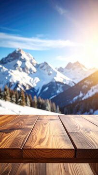 A wooden table surface is in the foreground with a scenic winter mountain landscape in the background under a bright sunlit sky.