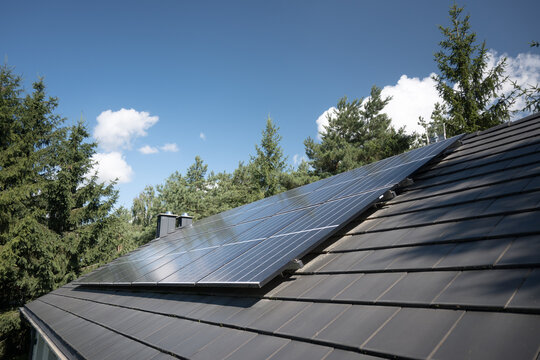 Photovoltaic panels on the house roof. Electricity generation.
