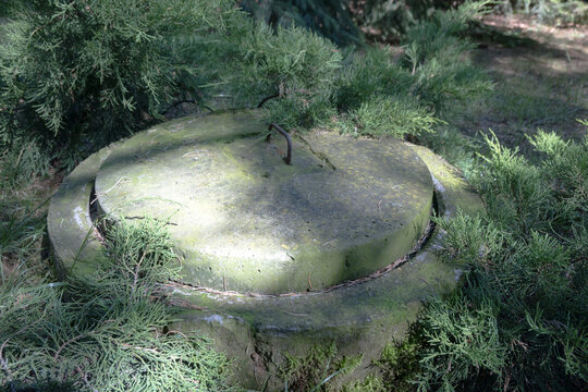 Concrete septic tank in front of a single-family house.