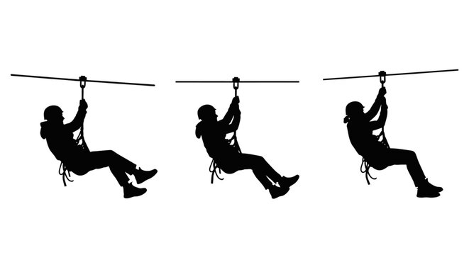 Silhouettes of people zip lining in action.