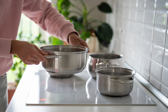 Scheduled turning off hot water system in modern houses, water service outage during pipeline outbreak, boiling cold water in pots on kitchen stove, temporary way to take shower by heating cold water
