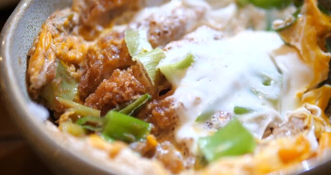 Close up of Japanese Katsudon pork cutlet rice bowl with egg