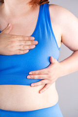 Breast test, woman in blue bra examining her breasts for cancer, mastitis ore mastopathy disease © staras