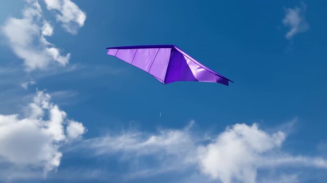 Purple wing kite suspended in bright blue sky with scattered white clouds and thin control line, creating vivid summer scene with clean minimal composition, with kite, purple, sky, cloud detail