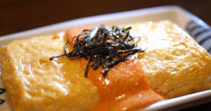 Close up of Japanese Tamagoyaki rolled omelet with Mentaiko sauce