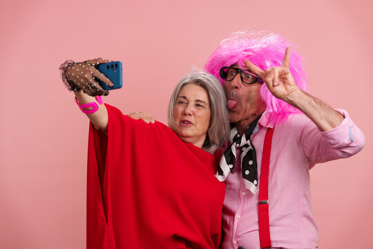 Mature couple taking fun selfie celebrating positive longevity