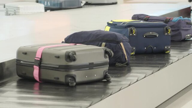 Baggage claim process at an airport showing luggage on a carousel during passenger arrival