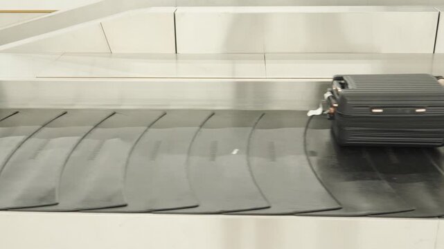 Baggage claim process at airport with luggage moving on conveyor belt