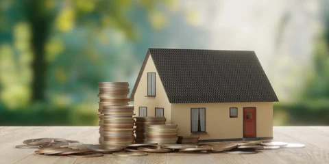 Miniature model house with money coins on wooden table over garden background, home or property investment concept © Shawn Hempel