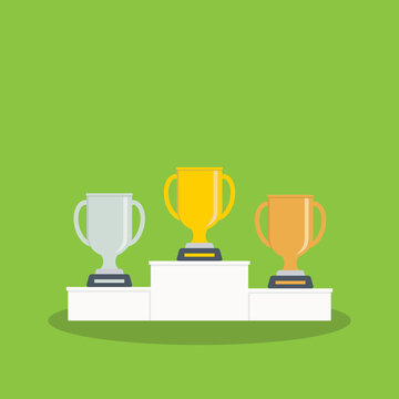 Golden, silver and bronze metallic trophy cups on a podium