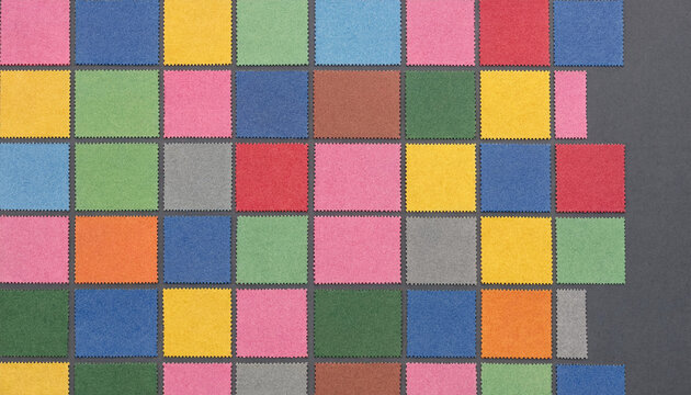 Colorful grid of square paper samples with serrated edges arranged on a dark gray background, showing various vibrant, pastel colors