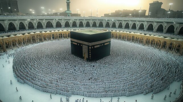 Aerial view of thousands of white-clad pilgrims forming concentric circles around the central black cube in a vast mosque courtyard at dawn, solemn and unified
