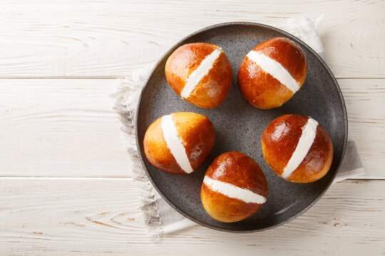 Maritozzi Italian sweet buns with cream close-up in a plate on the table. Horizontal top view from above