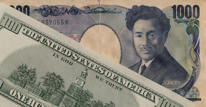 Japanese 1000 yen banknote and US 100 dollar banknote close up