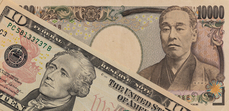 US 10 dollar banknote and Japanese 2000 yen banknote close up
