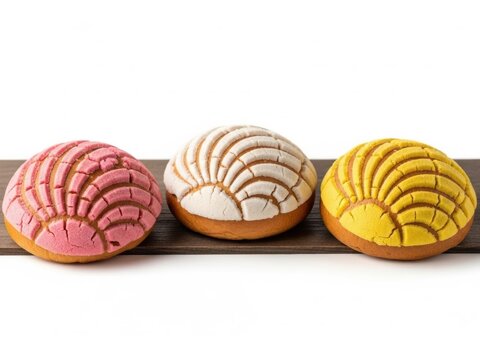 Three colorful concha sweet breads on wooden board