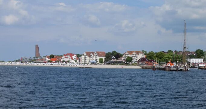 view of the Baltic Sea town of Laboe from the ferry on a sunny day, slow motion wide angle view with the Naval Memorial in the background, Germany, Schleswig-Holstein