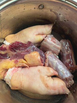 Raw pork meat set for traditional kholodets or aspic cooking. Assorted cuts including pork feet, shank and skin rich in collagen.