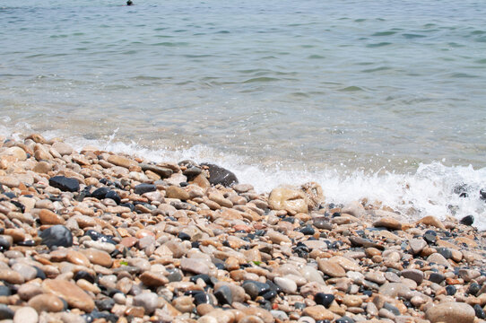 waves on the beach and pebbles