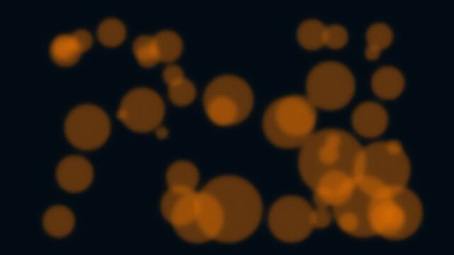 Orange bokeh lights on black background.