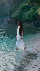 Fototapeta premium Serene shoreline woman finds peace barefoot on turquoise water lush cliffs backdrop tranquil morning light