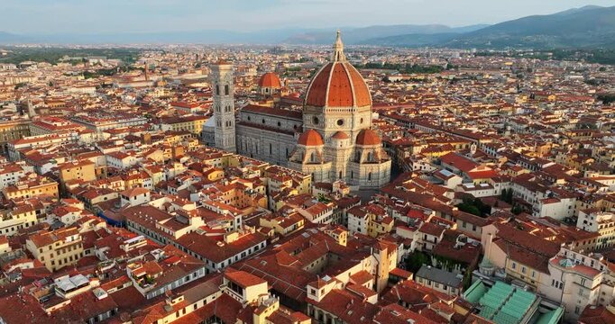 Florence Cathedral Santa Maria del Fiore Duomo grand aerial drone view red terracotta roofs traditional italian cityscape architecture sunset warm light travel destination Tuscany Italy Europe.
