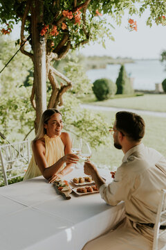 Romantic outdoor dining experience by the lake with delicious appetizers