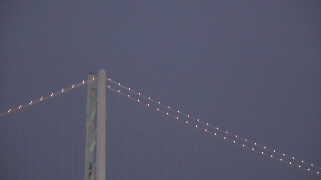 Close-up of Akashi Kaikyo Bridge Main Tower and Illuminated Cables at Dusk