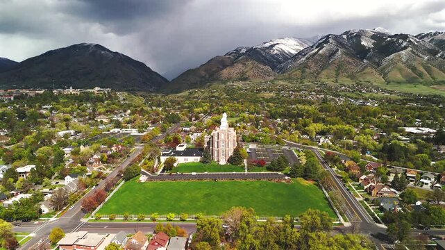 Drone pulls back from a hilltop landmark uncovering wide lawns and mountain scenery