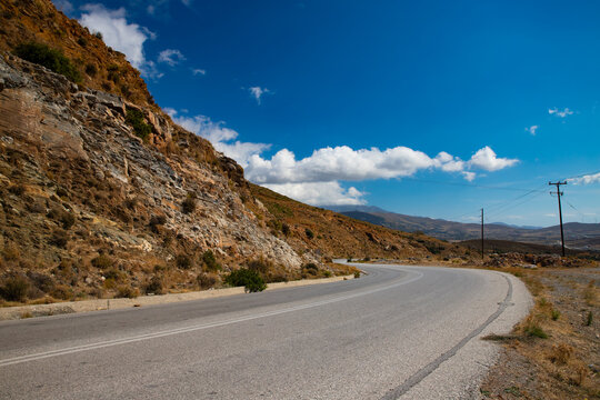 Empty, winding road along the coast of the mountainous Greek island of Euboea