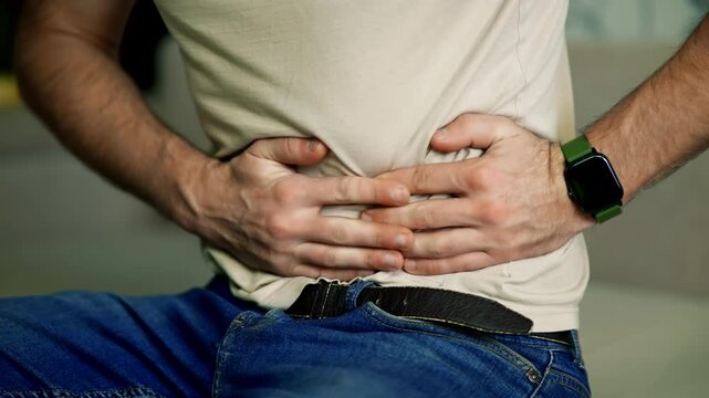 Patient Holding Belly Suffering From Stomach Ache. Gastritis Symptoms. Food Poisoning 